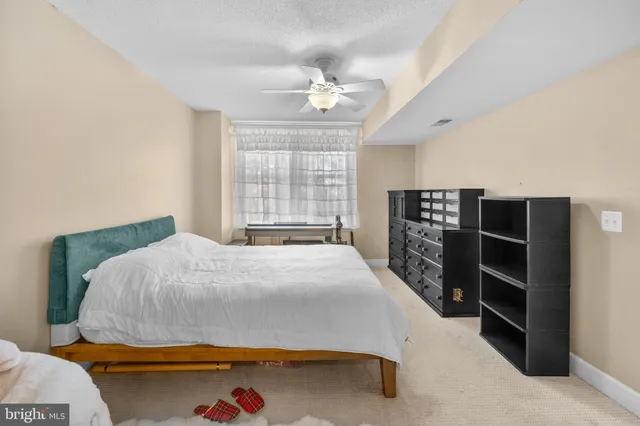 a bedroom with a bed and a bookshelf