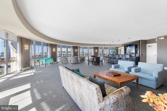 a dining room with furniture a chandelier and wooden floor