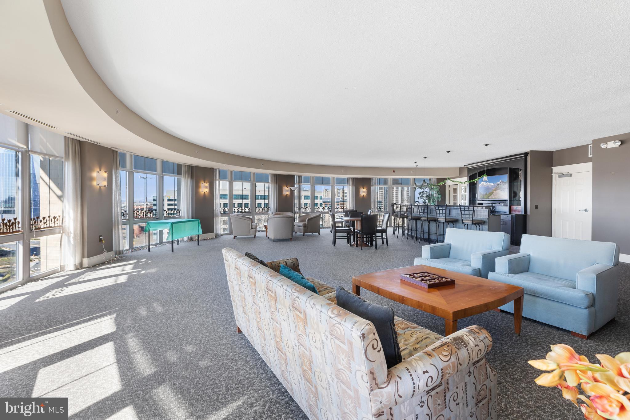 11800 Sunset Hills Road, Unit 409 Reston, VA 20190 - Photo 23 of 35 a living room with furniture and a table