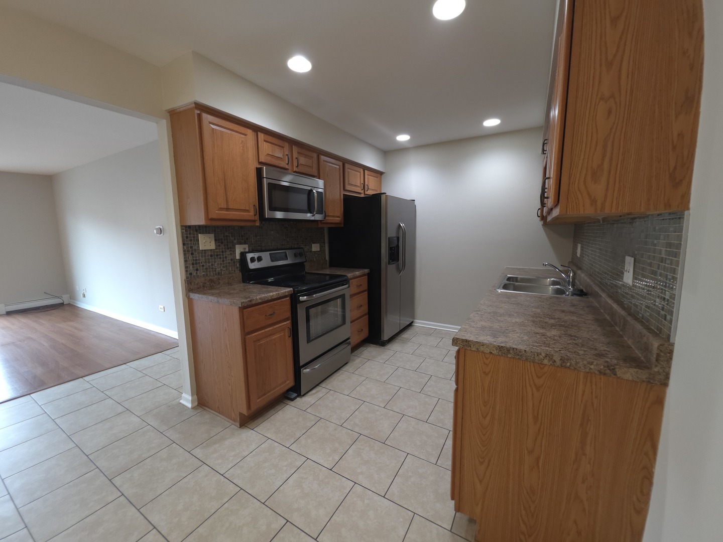 412 East Bailey Road, Unit 101 Naperville, IL 60565 - Photo 6 of 12 a kitchen with stainless steel appliances granite countertop a stove a sink and a refrigerator