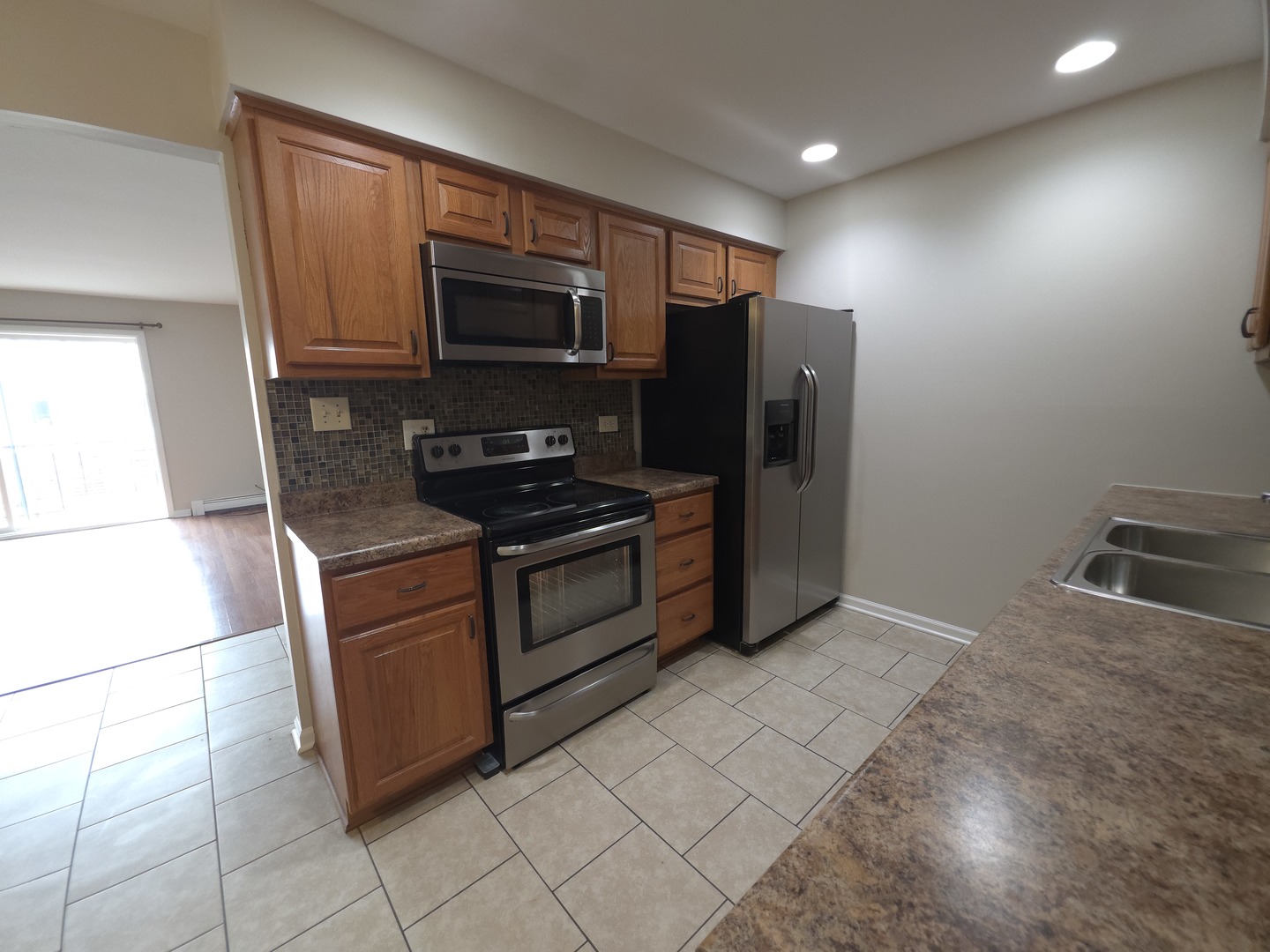 412 East Bailey Road, Unit 101 Naperville, IL 60565 - Photo 7 of 12 a kitchen with stainless steel appliances granite countertop a refrigerator and a stove top oven