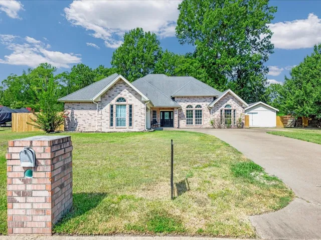 a house with green field in front of it
