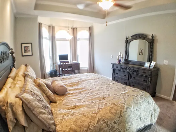 a bedroom with a large bed and a dresser