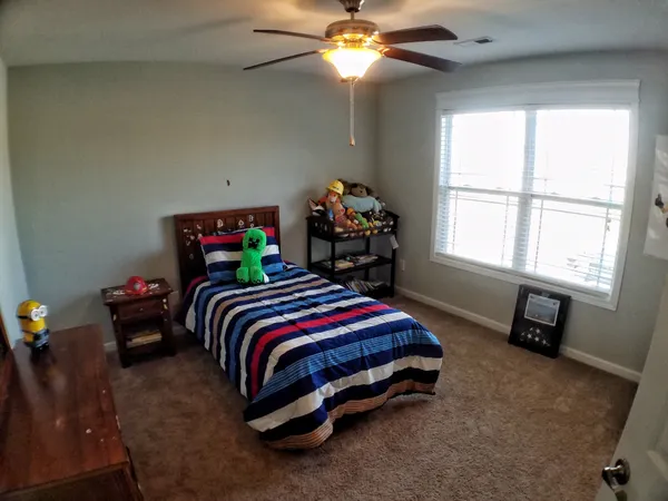 a bedroom with a bed and a chandelier
