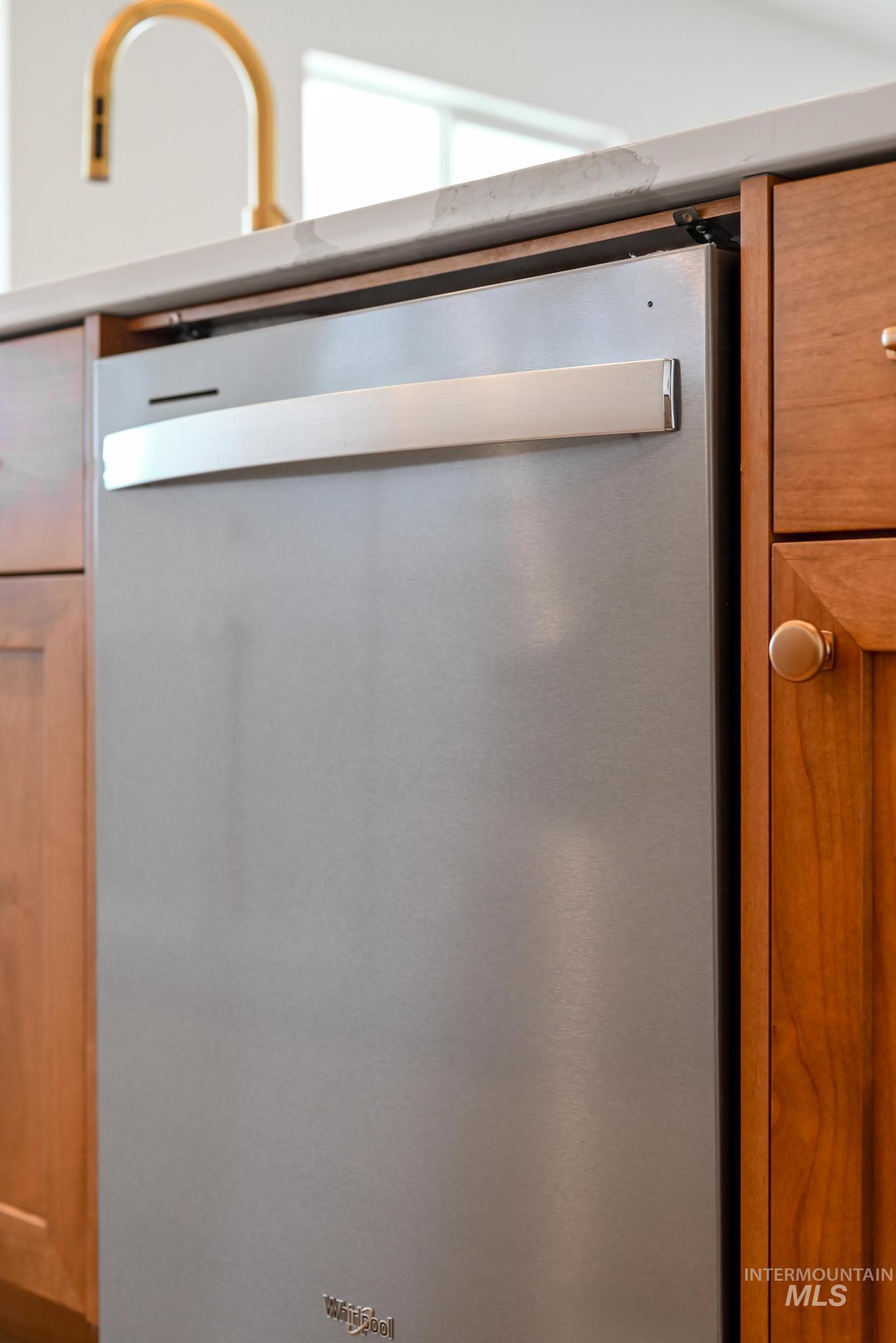 15216 Steel Cloud Avenue Caldwell, ID 83607 - Photo 13 of 32 Kitchen view of stainless steel dishwasher and wood finish cabinets