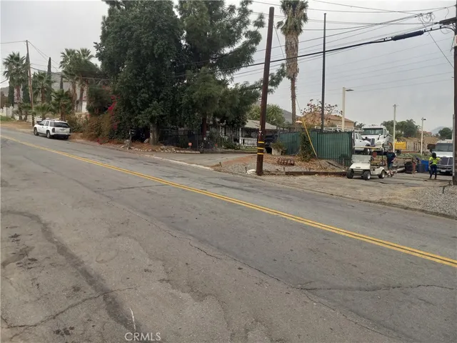 a view of street with a cars parked on the road