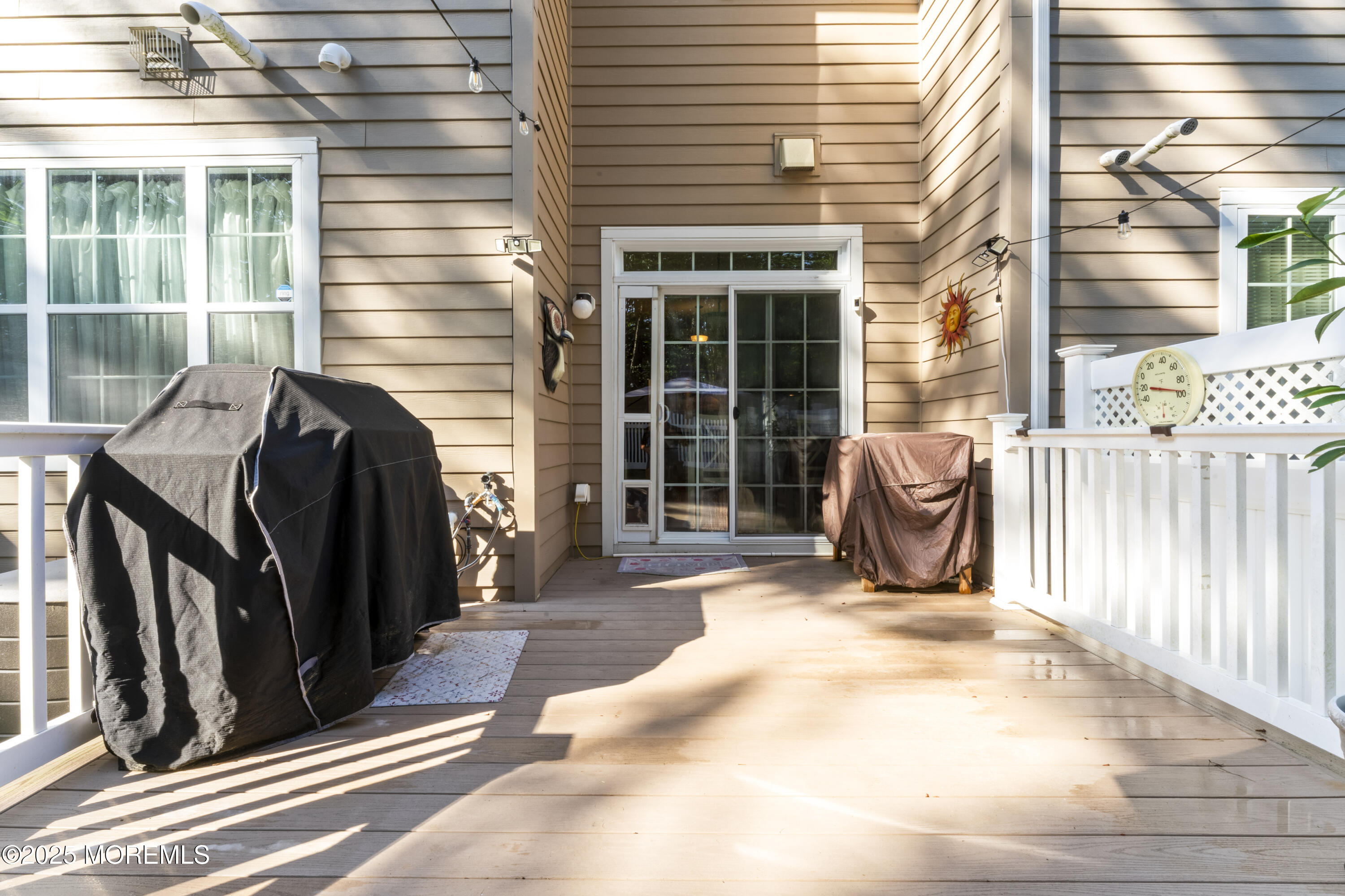 206 Hawthorne Lane Barnegat, NJ 08005 - Photo 37 of 49 a view of a patio with table and chairs and wooden floor