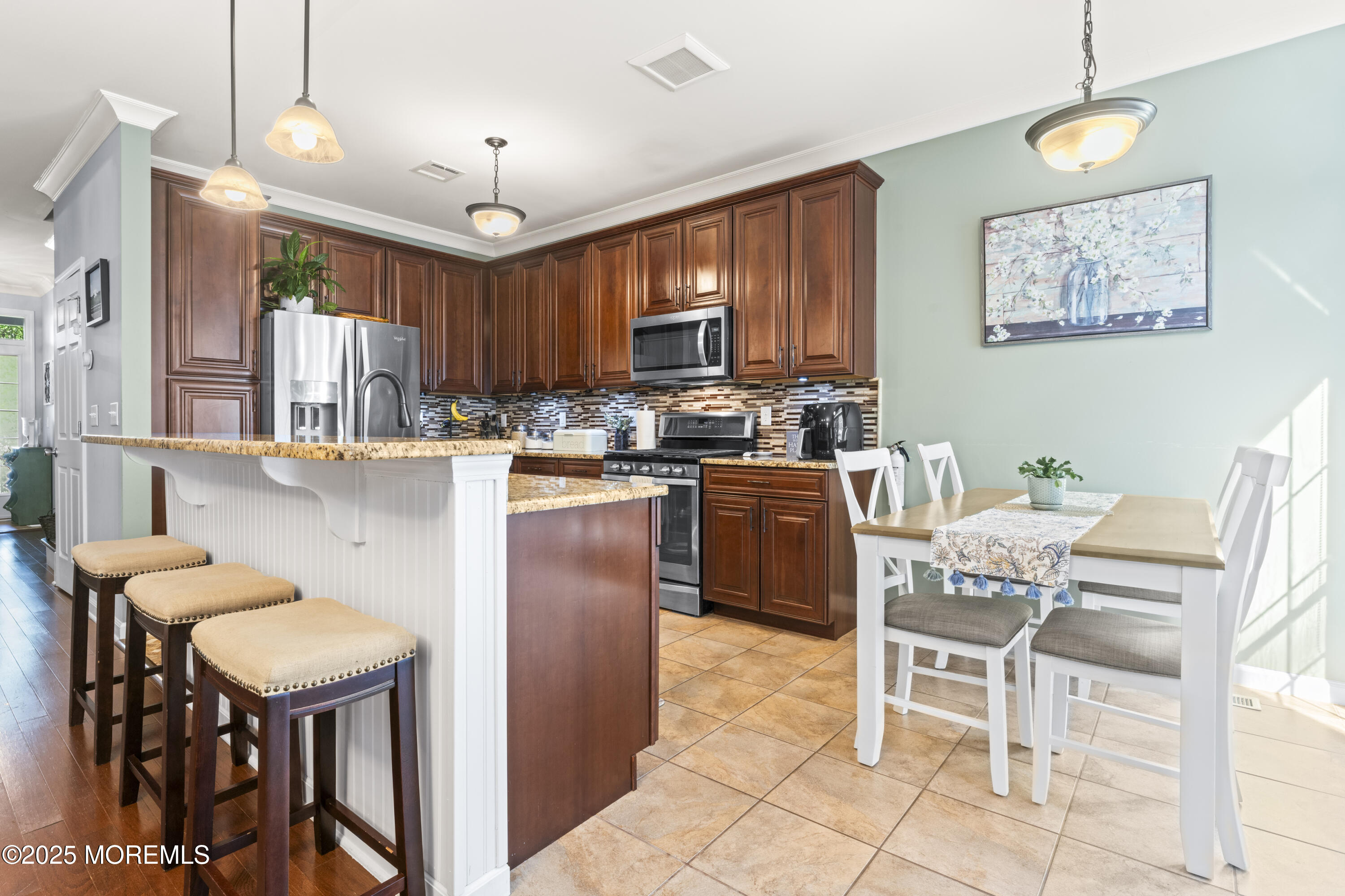 206 Hawthorne Lane Barnegat, NJ 08005 - Photo 9 of 49 a kitchen with a dining table chairs and refrigerator