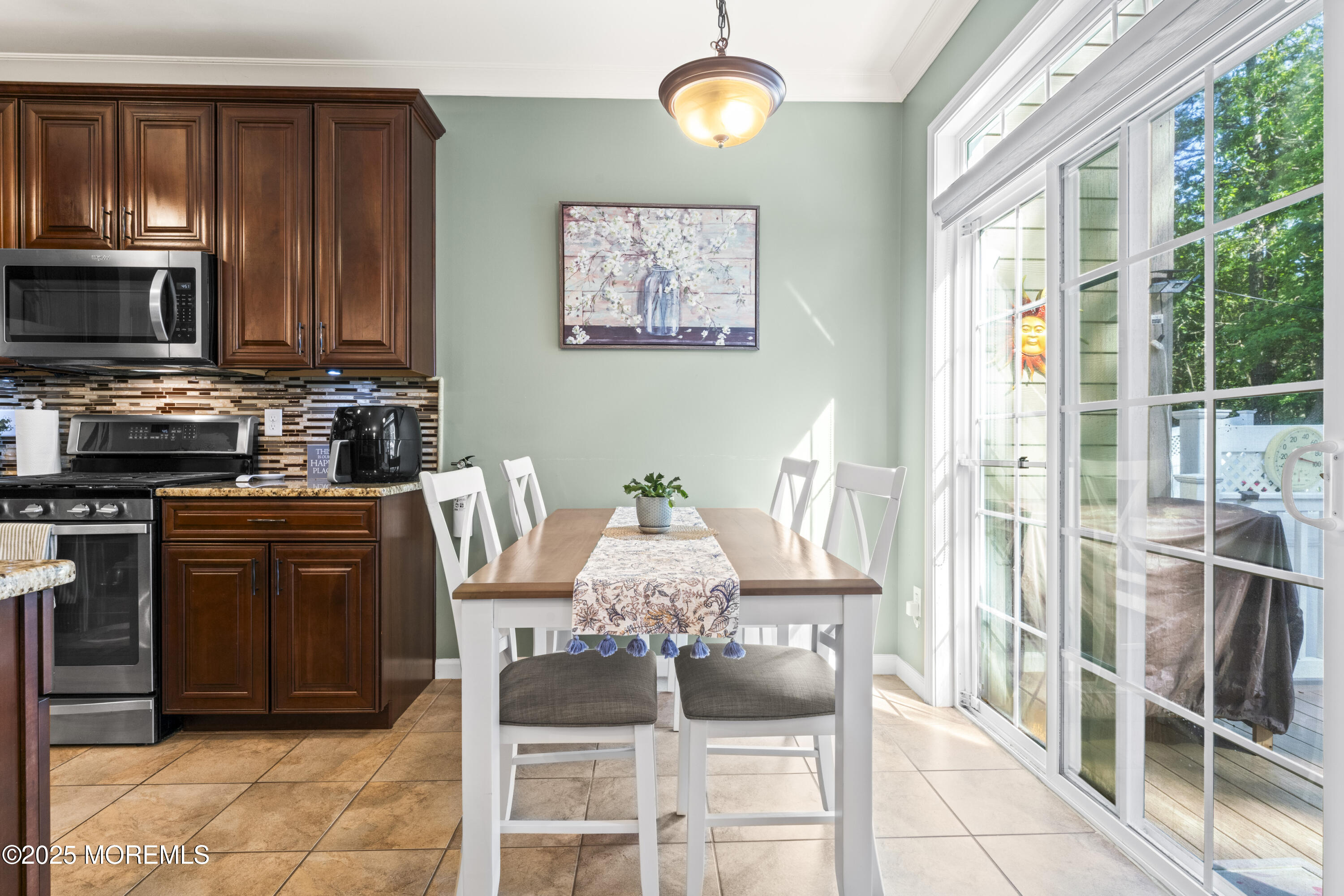 206 Hawthorne Lane Barnegat, NJ 08005 - Photo 10 of 49 a dining room with wooden floor a chandelier a wooden table and chairs