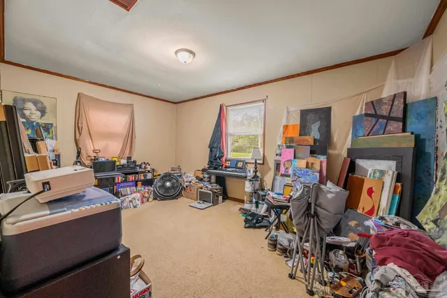 a view of a room with workspace and a window