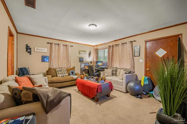 a living room with furniture a lamp and a large window
