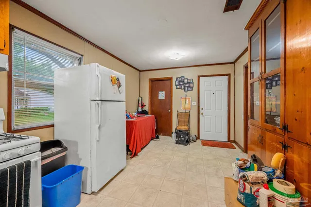 a kitchen with stainless steel appliances granite countertop a refrigerator and a stove