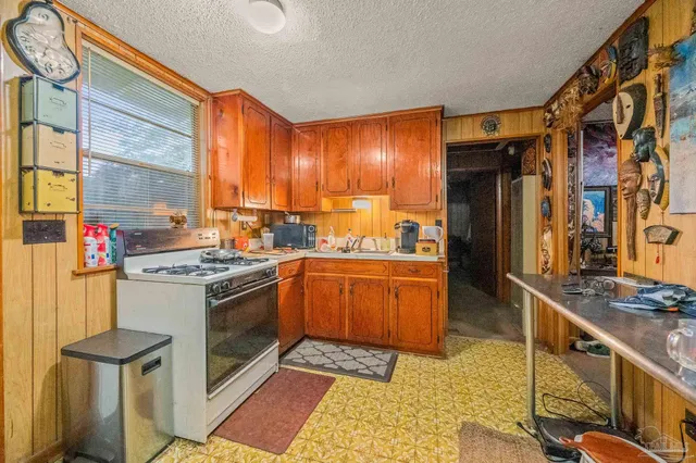 a kitchen with stainless steel appliances granite countertop a stove and a refrigerator