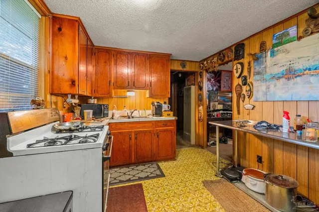 a kitchen with stainless steel appliances a stove a sink and a refrigerator