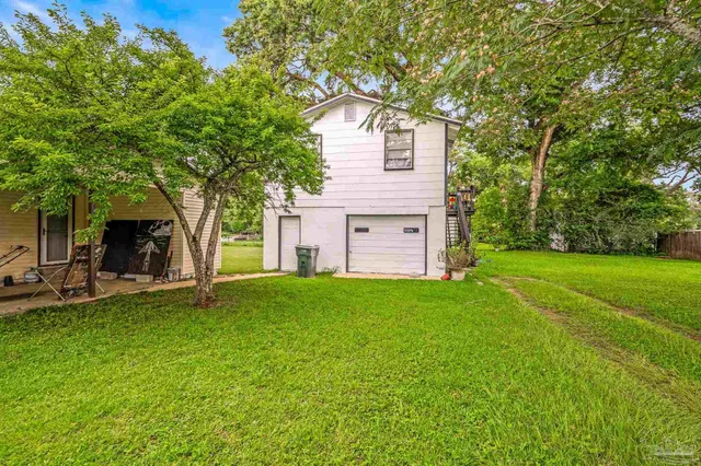 a house view with a sitting space and garden