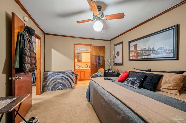 a bedroom with furniture and a large mirror