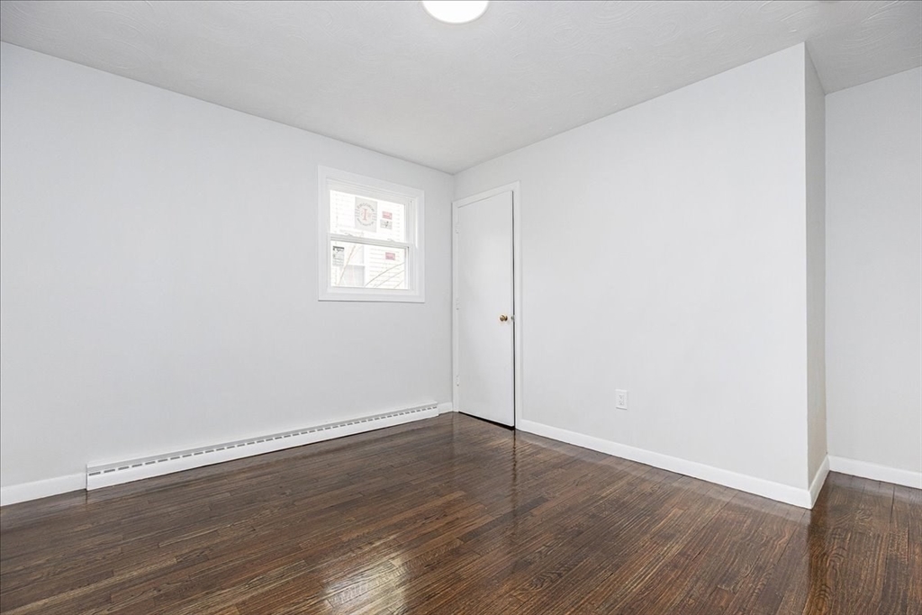 38 Warren Street Revere, MA 02151 - Photo 15 of 42 an empty room with wooden floor and windows
