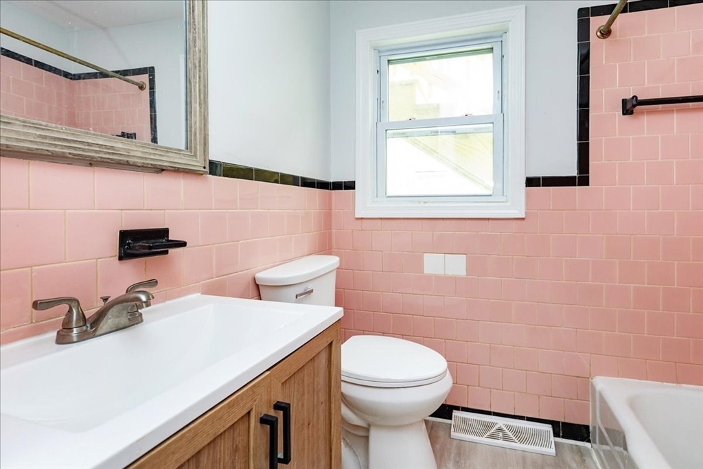 38 Warren Street Revere, MA 02151 - Photo 17 of 42 a bathroom with a sink a toilet and mirror