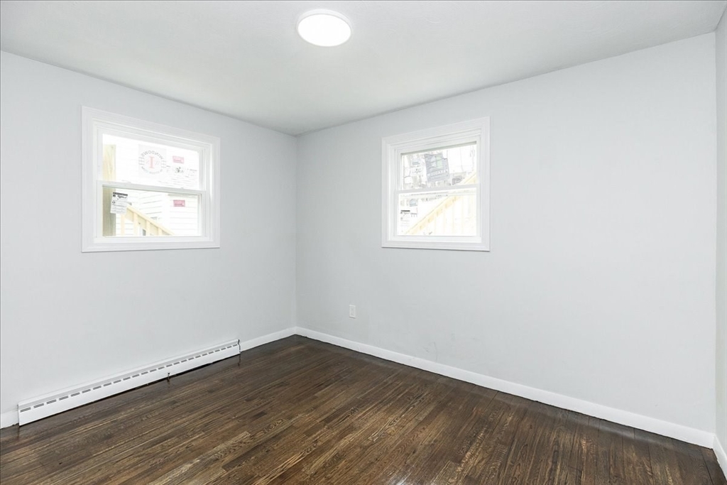 38 Warren Street Revere, MA 02151 - Photo 19 of 42 an empty room with wooden floor and windows