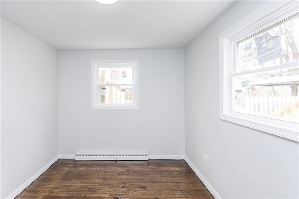 38 Warren Street Revere, MA 02151 - Photo 20 of 42 an empty room with wooden floor and windows