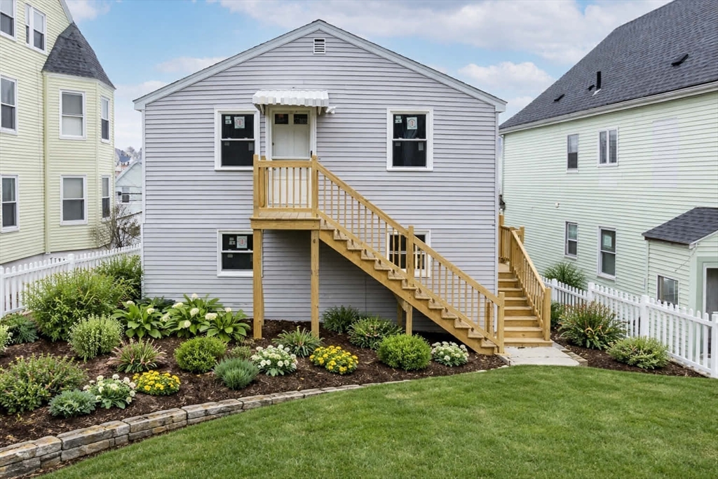 38 Warren Street Revere, MA 02151 - Photo 2 of 42 a front view of a house with a yard