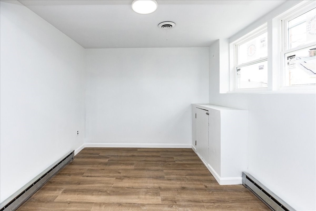 38 Warren Street Revere, MA 02151 - Photo 21 of 42 a view of a room with wooden floor and white walls
