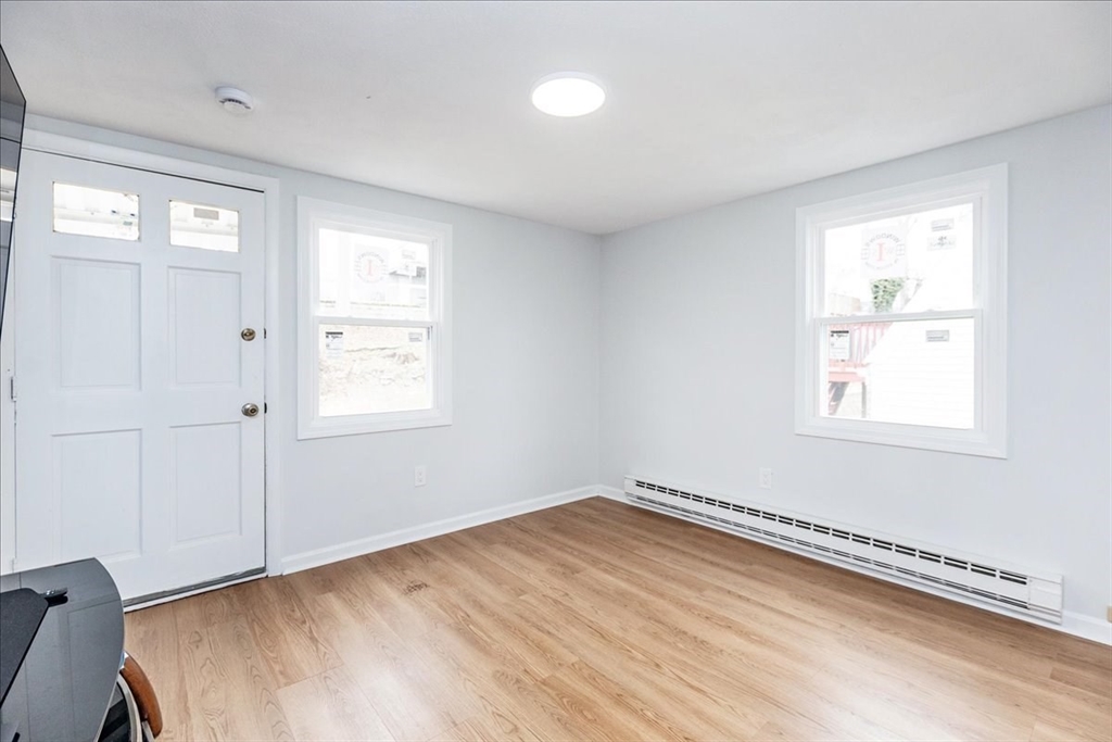 38 Warren Street Revere, MA 02151 - Photo 22 of 42 a view of a room with wooden floor and windows