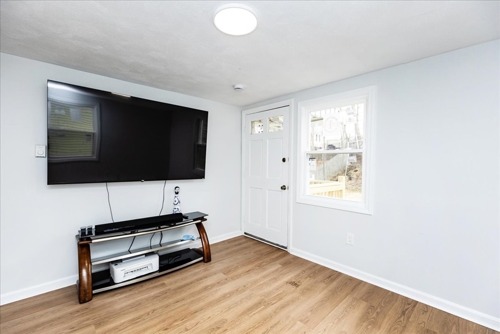 38 Warren Street Revere, MA 02151 - Photo 23 of 42 a living room with furniture and a flat screen tv