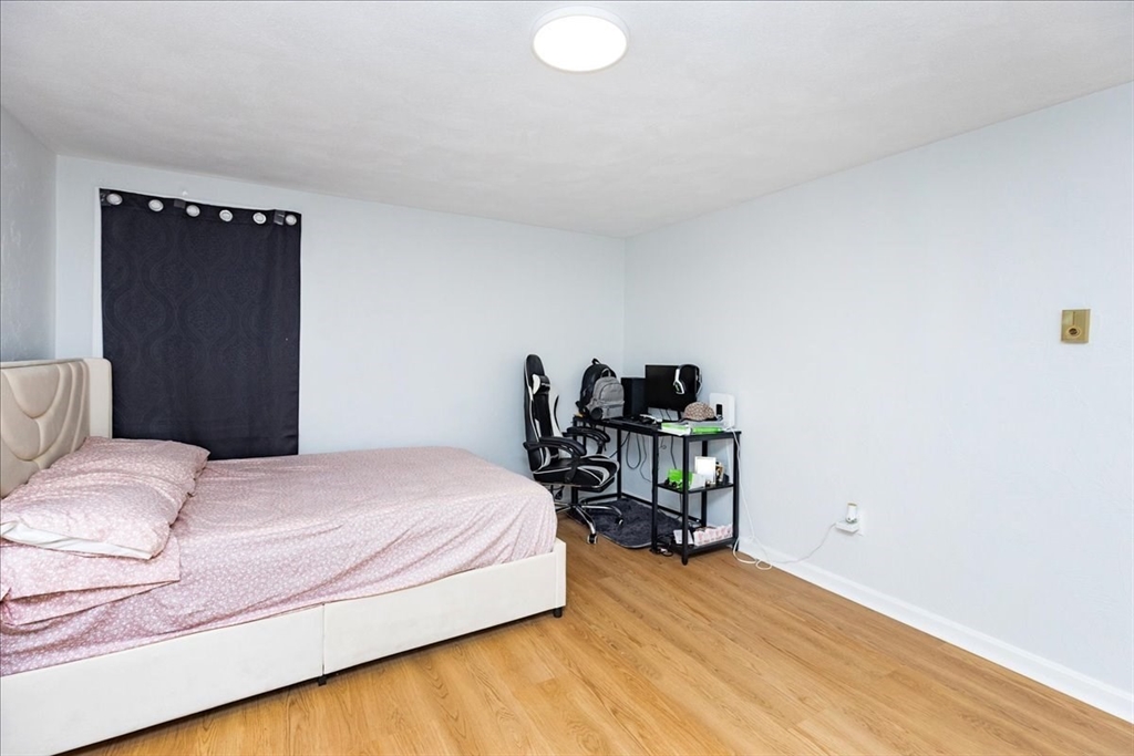 38 Warren Street Revere, MA 02151 - Photo 28 of 42 a bedroom with a bed and a chair