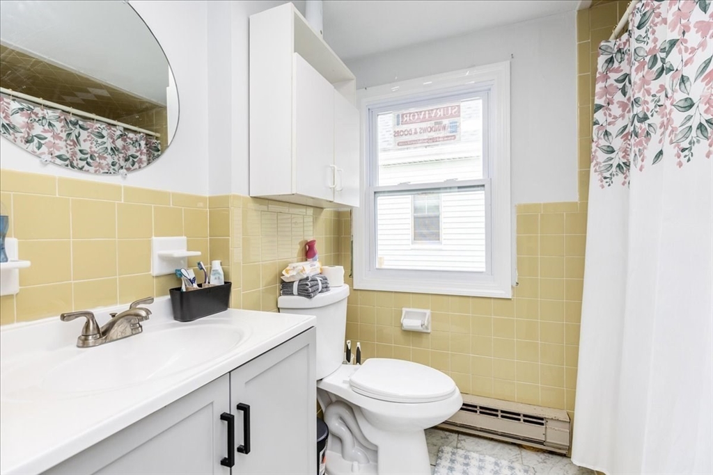 38 Warren Street Revere, MA 02151 - Photo 30 of 42 a bathroom with a sink a toilet and mirror