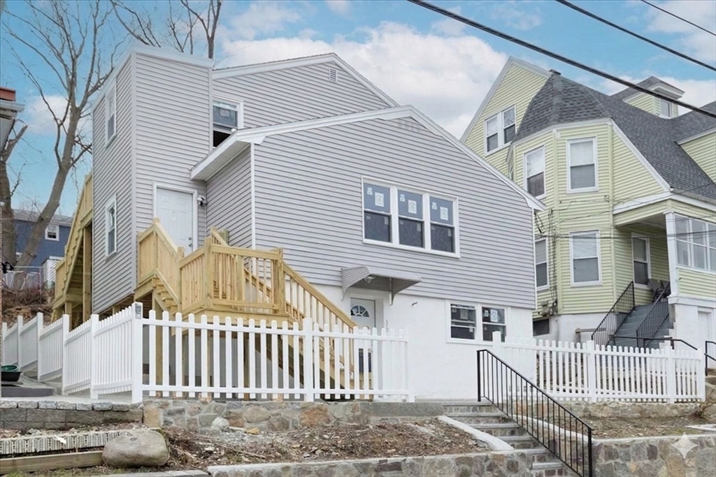 38 Warren Street Revere, MA 02151 - Photo 37 of 42 a view of a house with a small yard and wooden fence