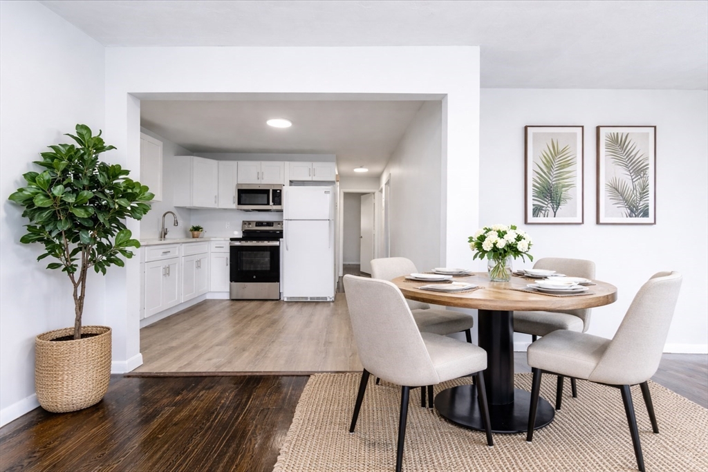 38 Warren Street Revere, MA 02151 - Photo 5 of 42 a view of a dining room with furniture and wooden floor