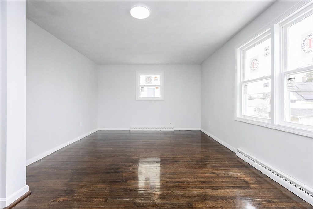38 Warren Street Revere, MA 02151 - Photo 7 of 42 an empty room with wooden floor and windows