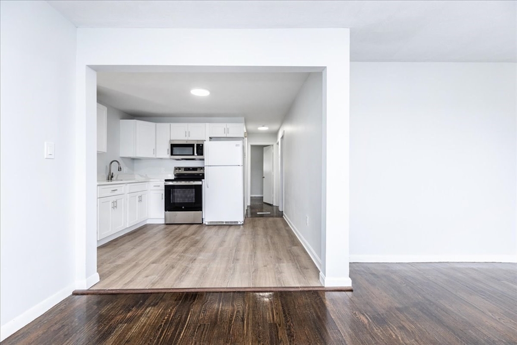 38 Warren Street Revere, MA 02151 - Photo 9 of 42 a view of kitchen with wooden floor electronic appliances and cabinets
