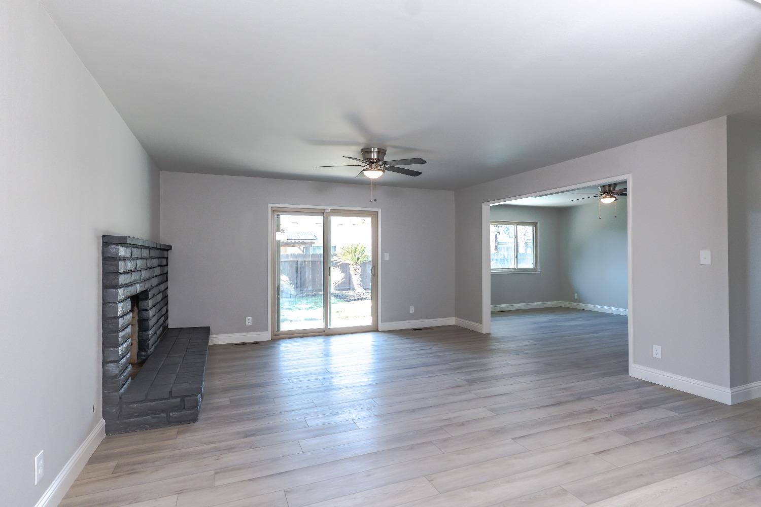 6587 North First Street Fresno, CA 93710 - Photo 13 of 51 a view of an empty room with a window and wooden floor