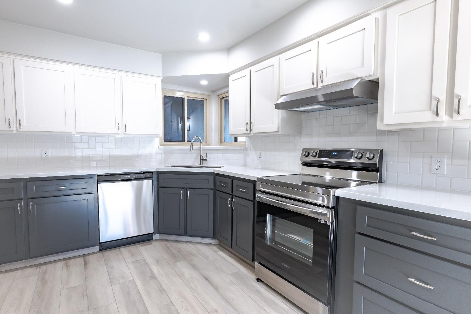 6587 North First Street Fresno, CA 93710 - Photo 16 of 51 a kitchen with stainless steel appliances granite countertop a sink a stove and cabinets