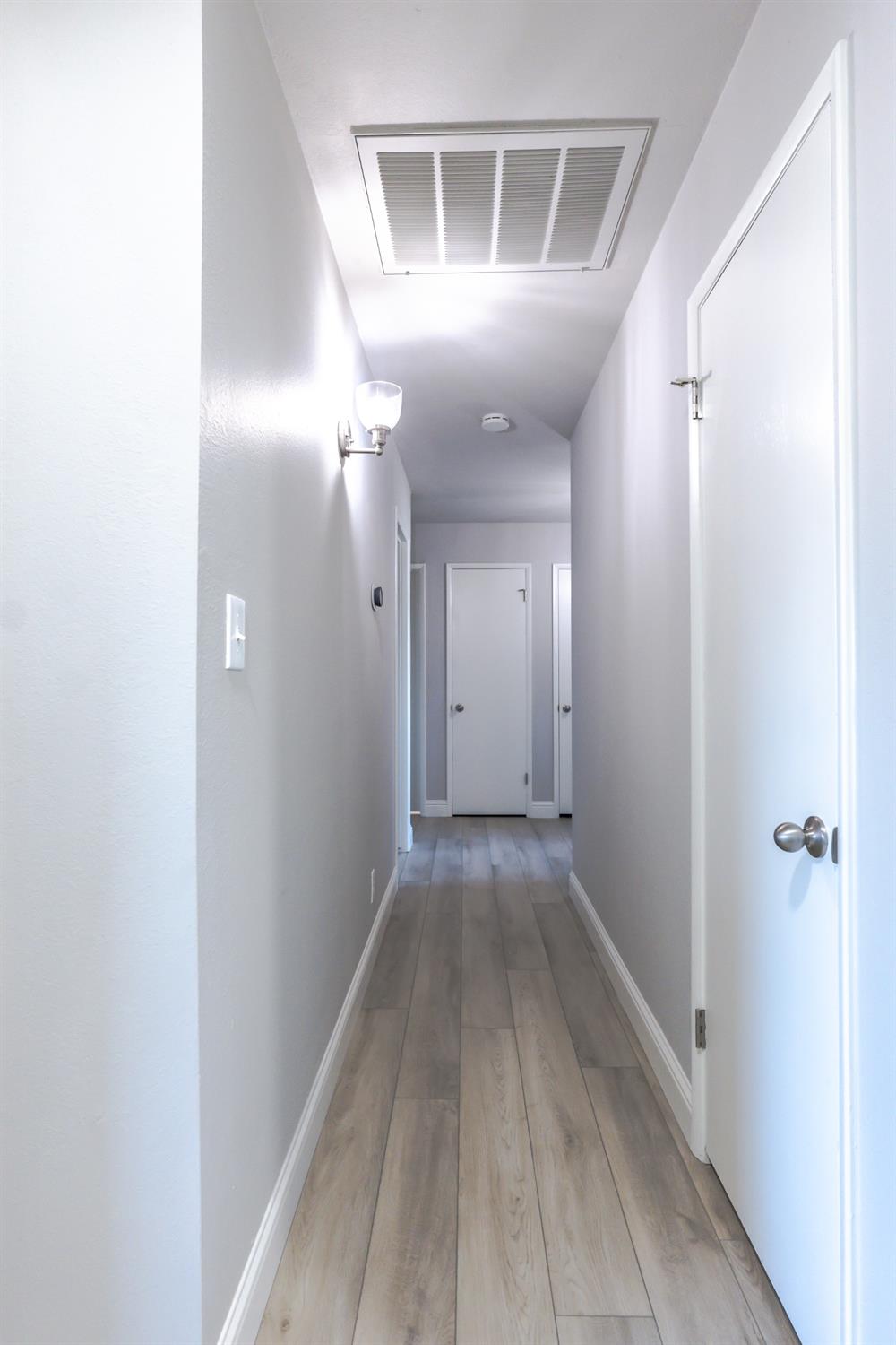 6587 North First Street Fresno, CA 93710 - Photo 19 of 51 a view of a hallway with wooden floor