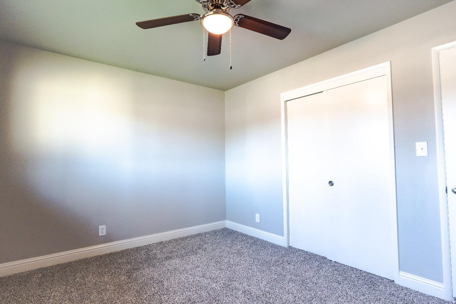 6587 North First Street Fresno, CA 93710 - Photo 20 of 51 an empty room with a ceiling fan and a window