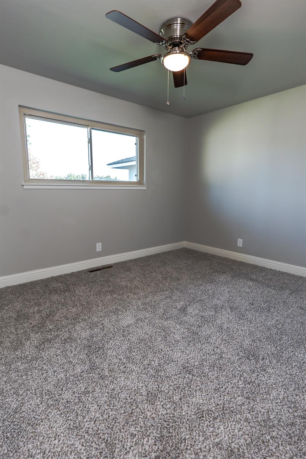 6587 North First Street Fresno, CA 93710 - Photo 22 of 51 an empty room with windows and fan