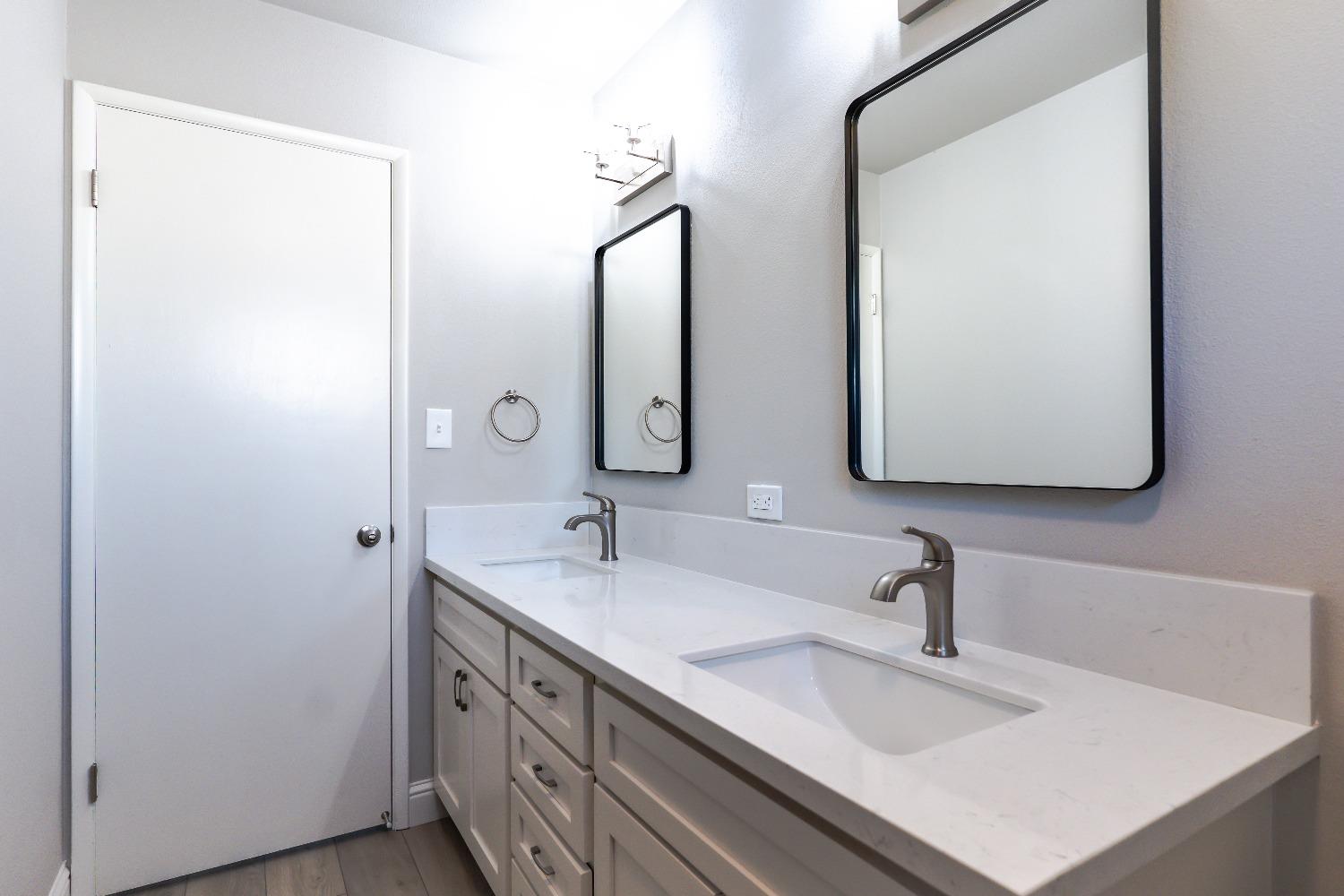 6587 North First Street Fresno, CA 93710 - Photo 26 of 51 a bathroom with a sink and a mirror