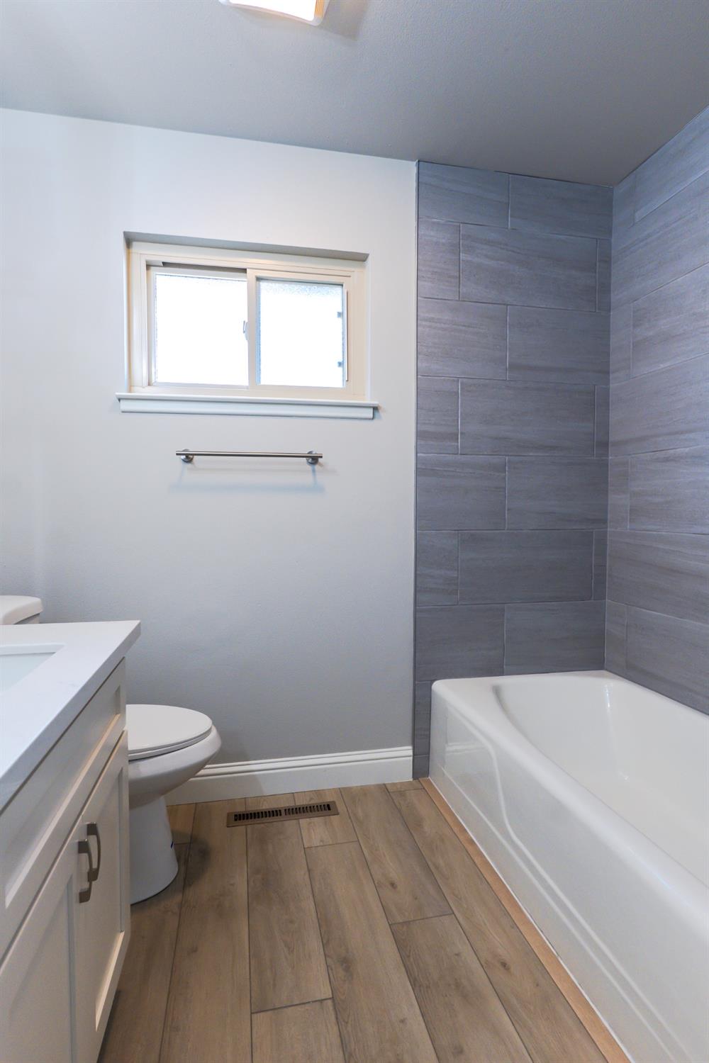 6587 North First Street Fresno, CA 93710 - Photo 27 of 51 a bathroom with a sink a toilet and a bathtub