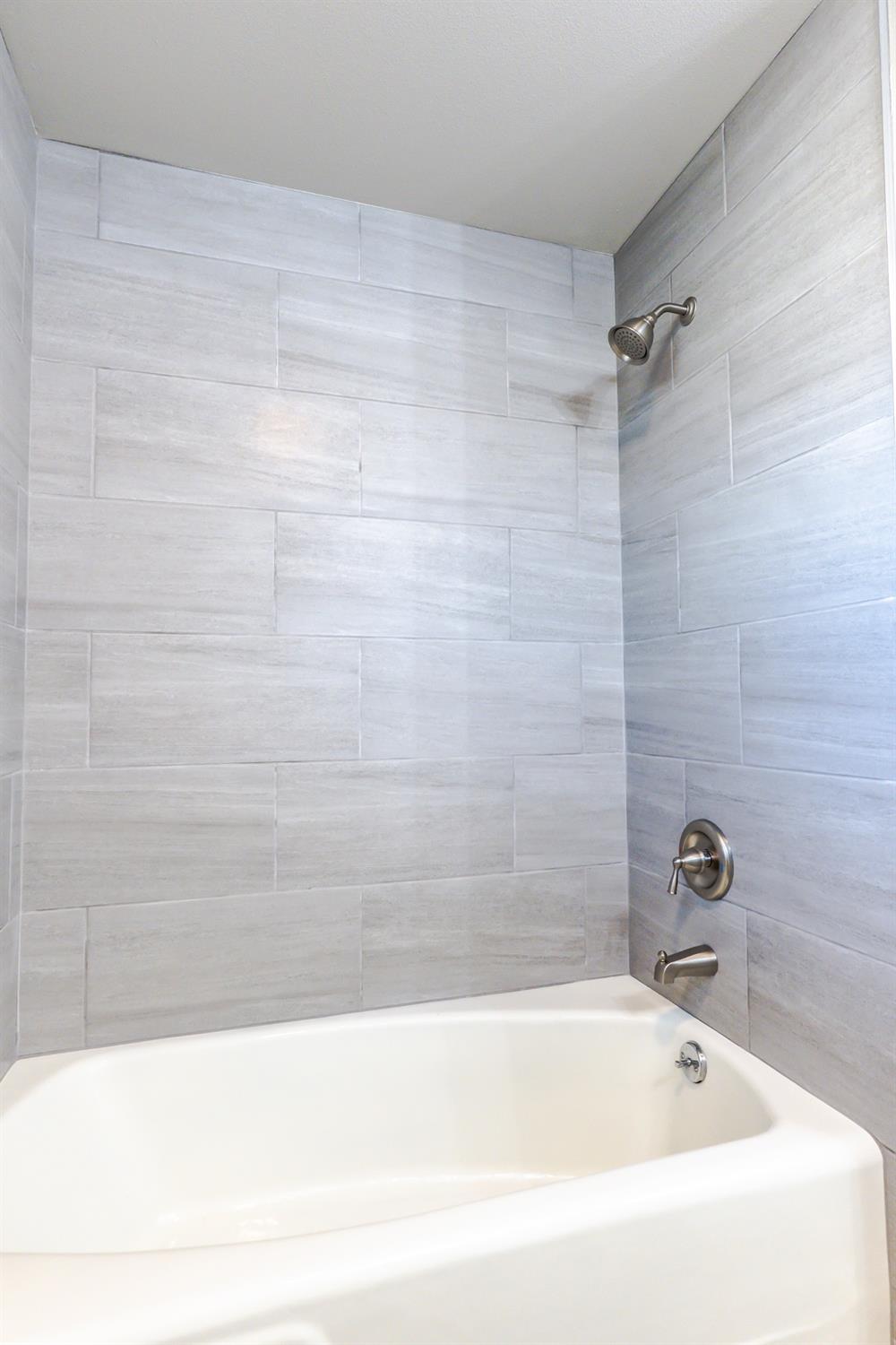 6587 North First Street Fresno, CA 93710 - Photo 28 of 51 a bathroom with a bathtub