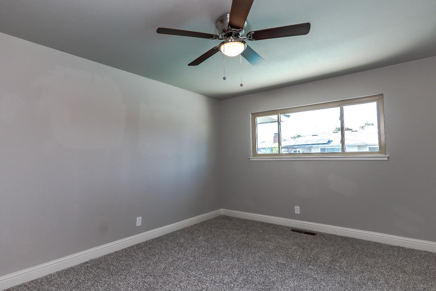 6587 North First Street Fresno, CA 93710 - Photo 29 of 51 an empty room with a window and a fan