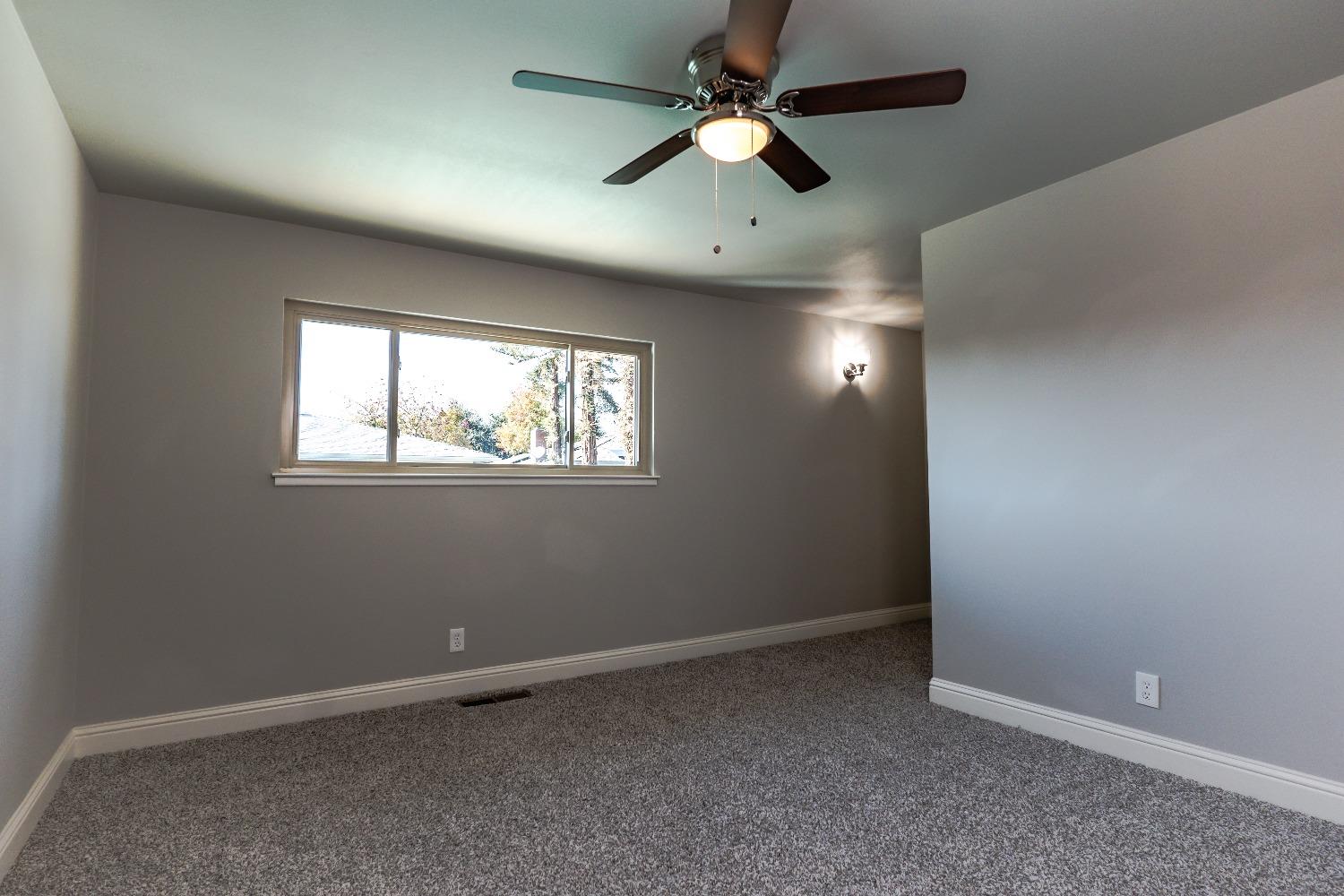 6587 North First Street Fresno, CA 93710 - Photo 30 of 51 an empty room with a window and a fan