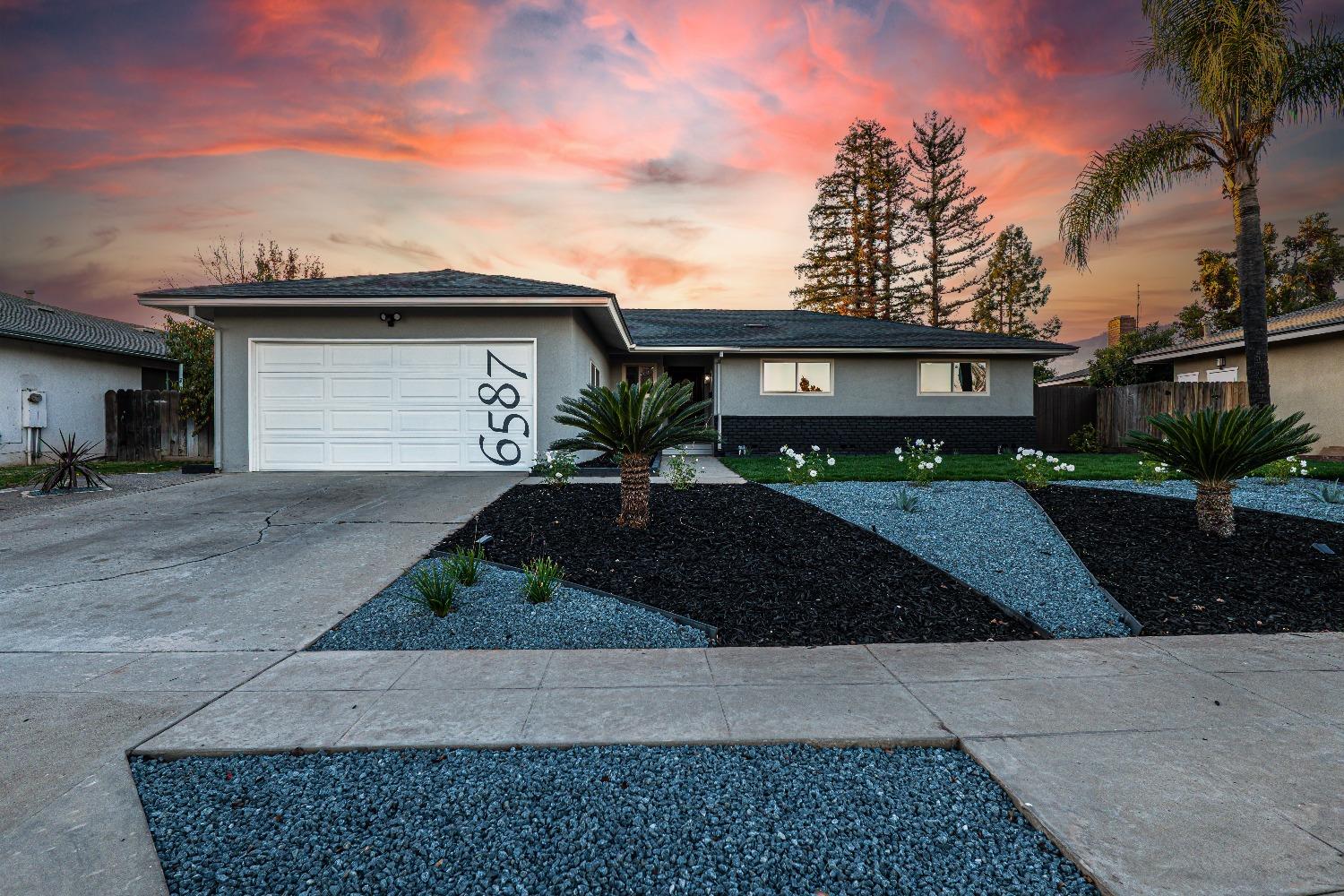 6587 North First Street Fresno, CA 93710 - Photo 3 of 51 a front view of a house with garage