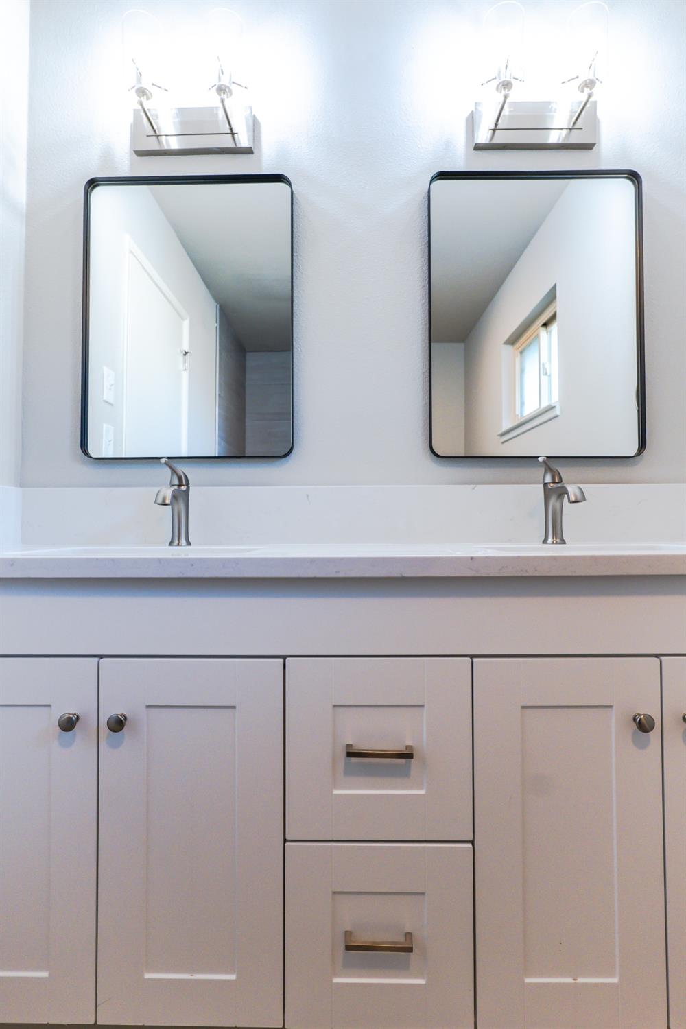 6587 North First Street Fresno, CA 93710 - Photo 35 of 51 a bathroom with a sink vanity and mirror