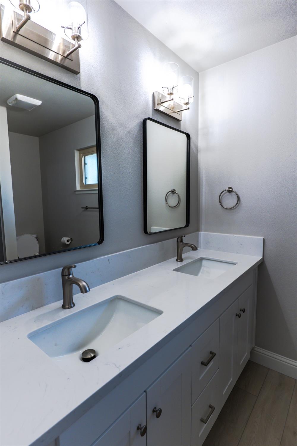 6587 North First Street Fresno, CA 93710 - Photo 37 of 51 a bathroom with a double vanity sink and a mirror