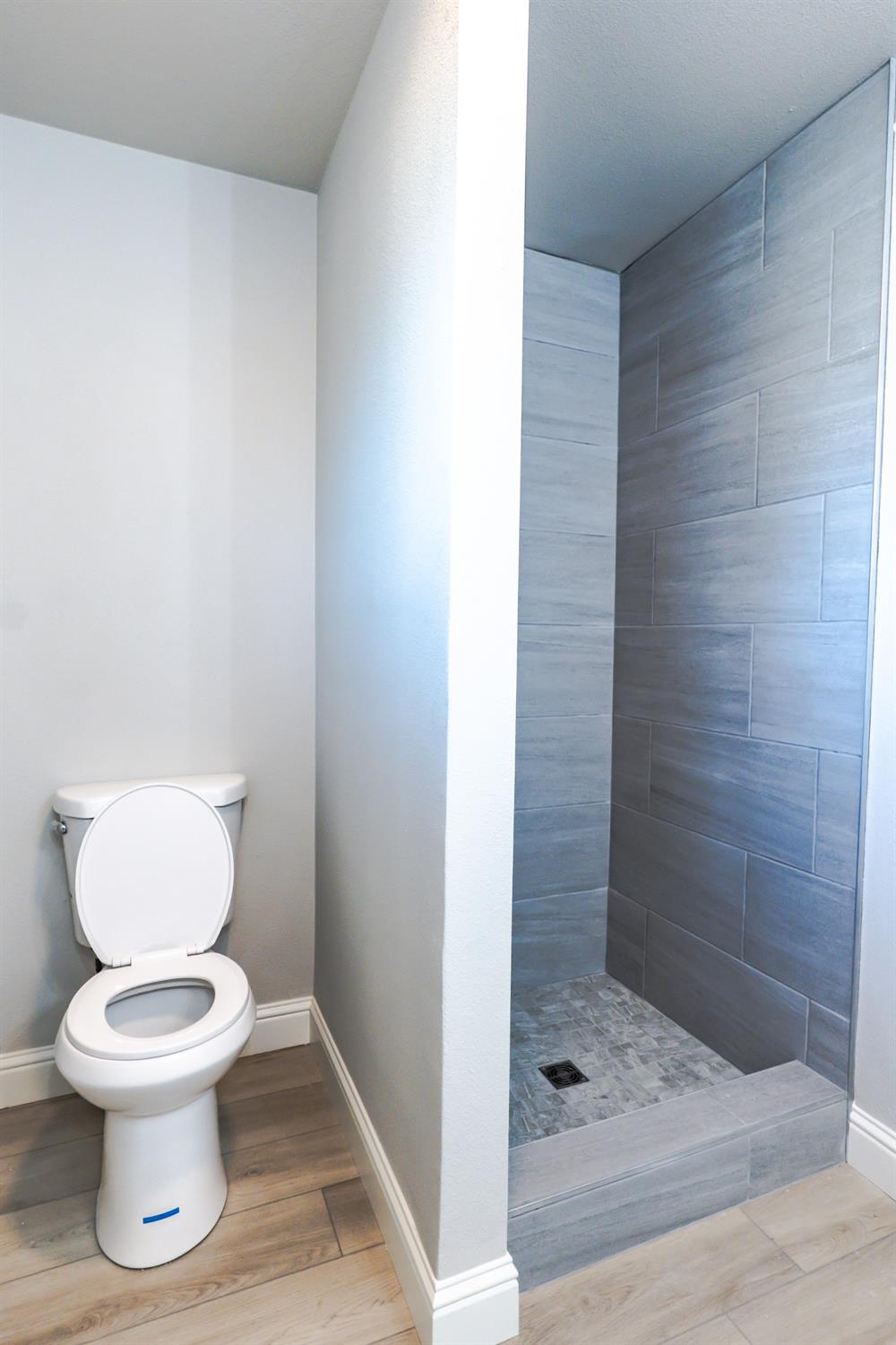 6587 North First Street Fresno, CA 93710 - Photo 39 of 51 a white toilet sitting next to a bathroom sink