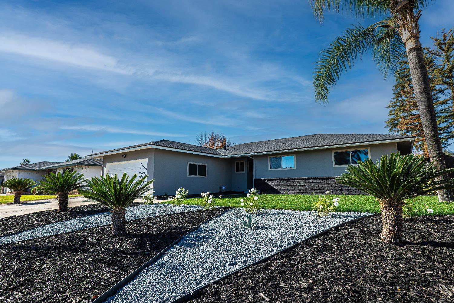 6587 North First Street Fresno, CA 93710 - Photo 4 of 51 a front view of a house with a yard