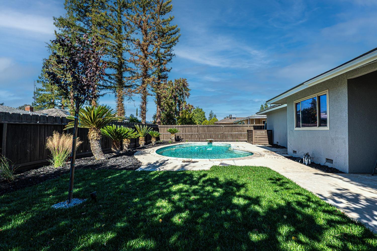 6587 North First Street Fresno, CA 93710 - Photo 41 of 51 a swimming pool with yard and outdoor seating